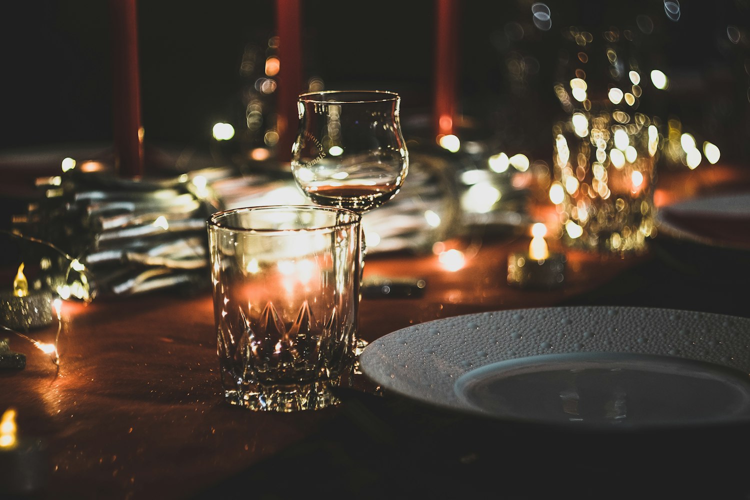 Candle-lit dinner table with glasses